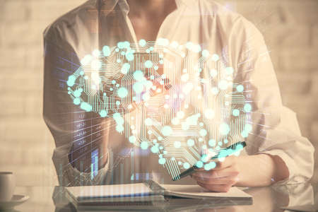 Double exposure of brain sketch hologram and woman holding and using a mobile device.