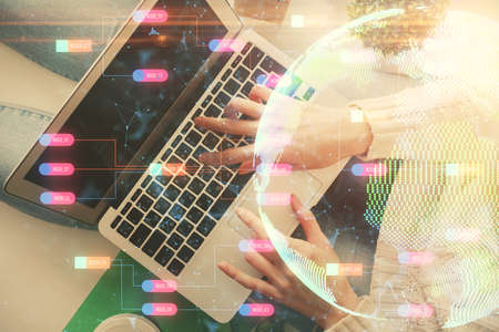 Double exposure of woman hands working on computer and world map hologram drawing. Top View. International business concept.の写真素材
