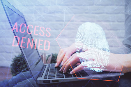 Double exposure of woman hands typing on computer and fingerprint drawing. Security concept.の写真素材