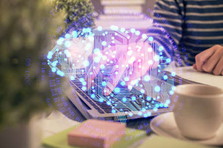Double exposure of woman hands working on computer and brain hologram drawing. Ai concept.