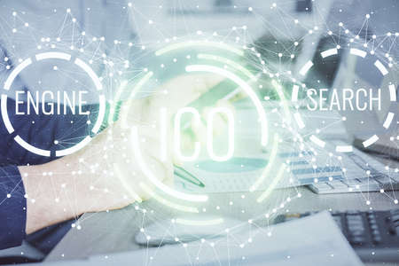 Double exposure of man's hands holding and using a phone and crypto currency blockchain theme drawing.の写真素材