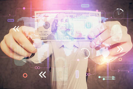 Double exposure of world map drawing hologram and us dollars bills and man hands.