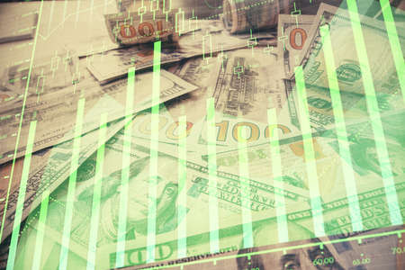 Multi exposure of forex chart drawing over us dollars bill background. Concept of financial success...