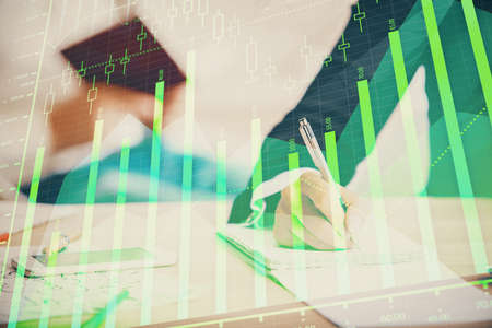 Double exposure of forex chart drawing over people taking notes background. Concept of financial analysisの写真素材