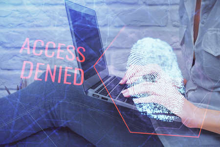 Double exposure of woman hands typing on computer and fingerprint drawing. Security concept.