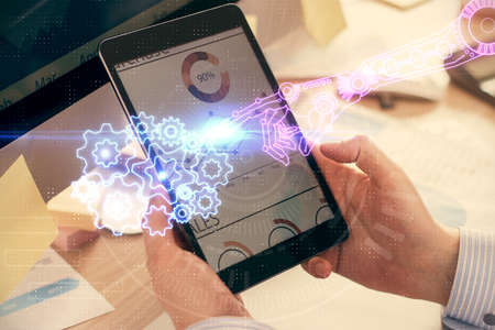 Multi exposure of man's hands holding and using a digital device and data theme drawing. Innovation...