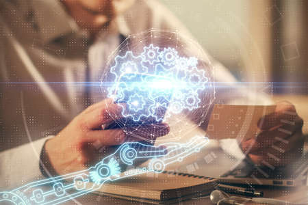 Multi exposure of man's hands holding and using a digital device and data theme drawing. Innovation...