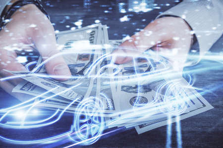 Multi exposure of Tech taxi drawing hologram and USA dollars bills and man hands. Technology concept.の写真素材