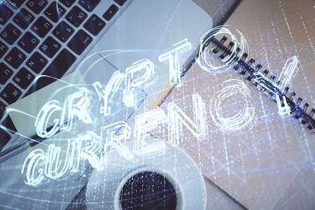 Blockchain theme hologram drawings over computer on the desktop background. Top view. Double...