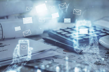 Double exposure of ENVELOP flying drawings and desk with open notebook background. Concept of e-mail