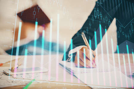 Double exposure of forex chart drawing over people taking notes background. Concept of financial...
