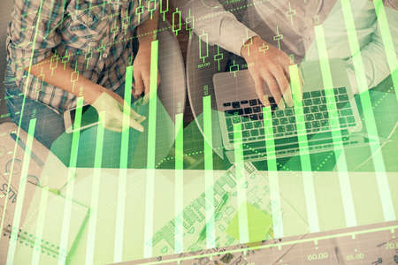 Multi exposure of man and woman working together and forex graph hologram drawing. Financial...