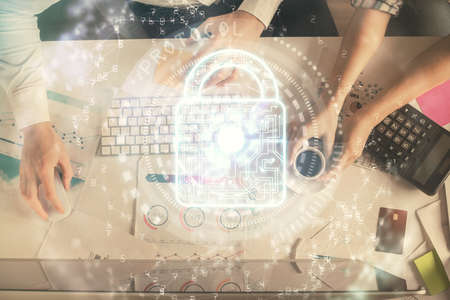 Double exposure of man and woman working together and lock hologram drawing. Security concept....