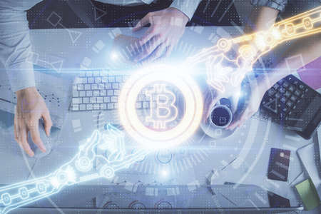 Double exposure of man and woman working together and crypto theme hologram drawing. Computer...