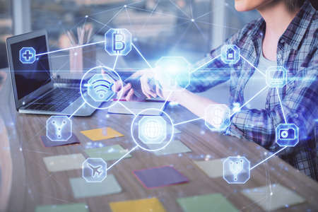 Double exposure of woman hands typing on computer and social network theme hologram drawing. People...