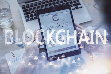 Double exposure of man's hands holding and using a phone and crypto currency blockchain theme drawing.の写真素材