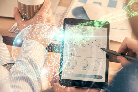 Multi exposure of man's hands holding and using a digital device and data theme drawing. Innovation...