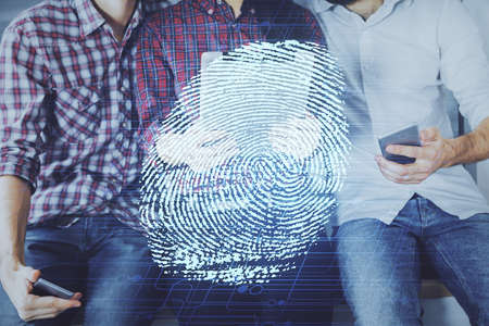 Double exposure of fingerprint hologram and man and woman working together holding and using a...