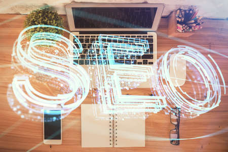 Double exposure of SEO drawing over study table background with computer. Concept of search. Top view.の写真素材