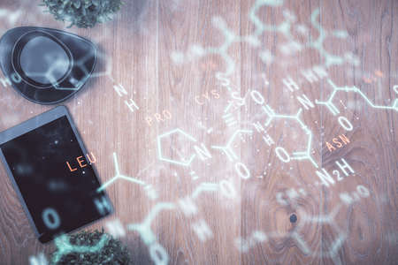 Double exposure of formula drawing over table with phone. Top view. Education concept.の写真素材