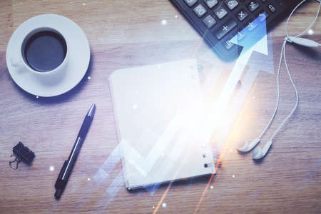 Double exposure of arrows drawing and work table top veiw. Concept of growth.