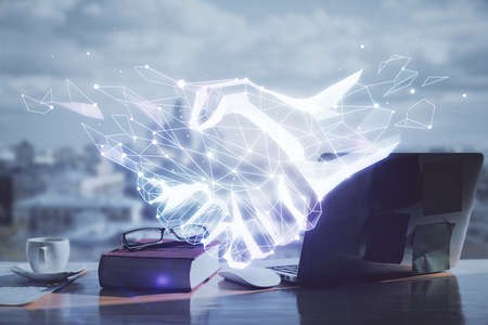 Double exposure of handshake flying drawings and desk with open notebook background. Concept of partnershipの写真素材