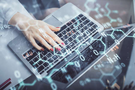 Double exposure of woman hands typing on computer and formula hologram drawing. Education concept.の写真素材