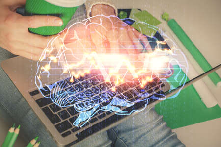Double exposure of woman hands working on computer and brain hologram drawing. Ai concept.