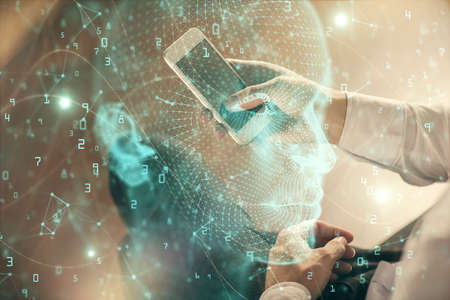 Double exposure of man's hand holding and using a digital device and brain hologram drawing. Data concept.の写真素材