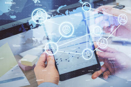 Double exposure of man's hands holding and using a phone and social network theme drawing.