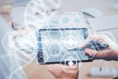 Double exposure of man's hands holding and using a phone and DNA drawing. Medical education concept.の写真素材