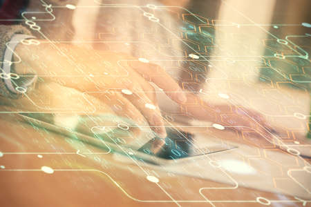 Double exposure of data theme hologram drawing and man and woman working together holding and using a mobile device.の写真素材