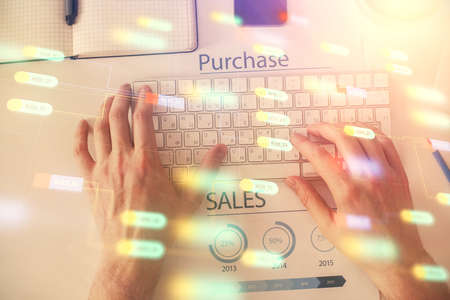 Multi exposure of man's hands typing over computer keyboard and data theme hologram drawing. Top view. Technology concept.の写真素材