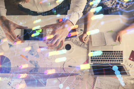 Double exposure of man and woman working together and data theme hologram drawing. Computer background. Top View.の写真素材
