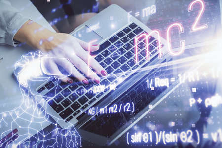 Double exposure of woman hands typing on computer and formula hologram drawing. Education concept.