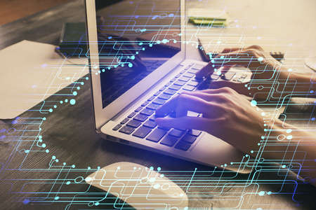 Double exposure of woman hands working on computer and data theme hologram drawing. Tech concept.の写真素材