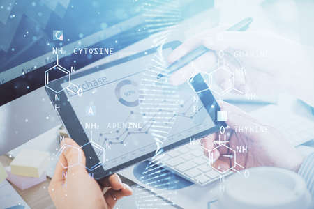 Double exposure of man's hands holding and using a phone and DNA drawing. Medical education concept.