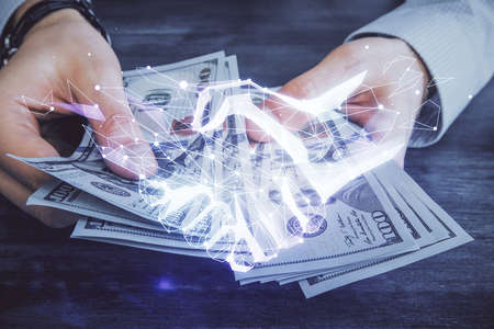 Multi exposure of handshake drawing hologram and USA dollars bills and man hands.の写真素材