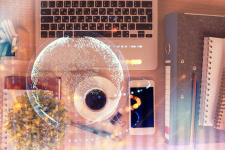 Double exposure of map hologram drawing over desktop. Top view. International connection concept.の写真素材