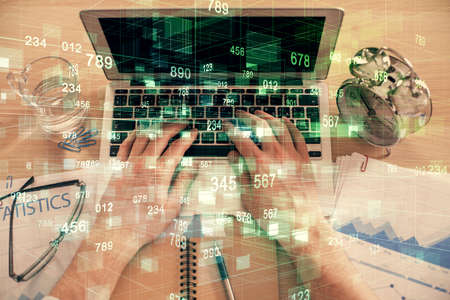 Double exposure of man's hands typing over computer keyboard and data theme hologram drawing. Top...