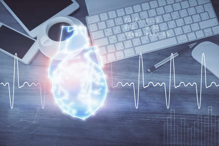 Double exposure of heart drawing over table with phone. Top view. Medical education concept.