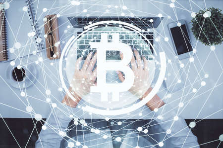 Double exposure of woman hands working on computer and blockchain theme hologram drawing. Top View. bitcoin cryptocurrency concept.の写真素材