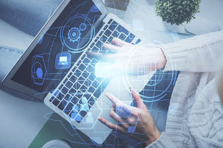 Double exposure of woman hands working on computer and social network theme hologram drawing. Top View. People connection concept.の写真素材