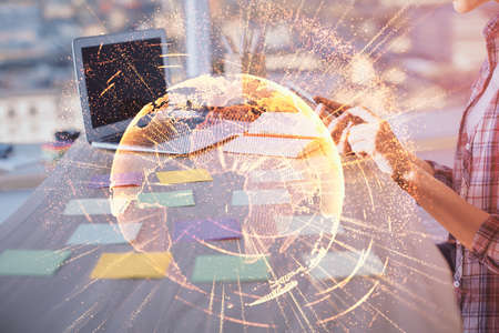 Double exposure of woman hands typing on computer and social network theme hologram drawing. People media concept.の写真素材
