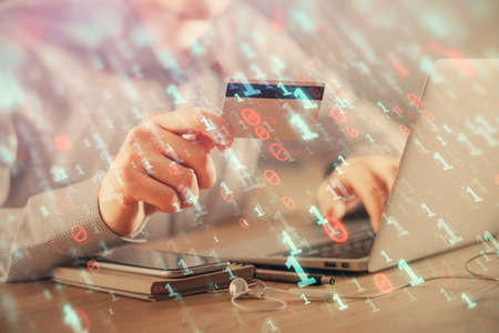 Double exposure of man hands holding a credit card and data theme drawing. E-commerce and technology...