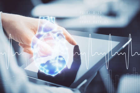 Double exposure of man's hands holding and using a phone and heart drawing. Medical education concept.の写真素材