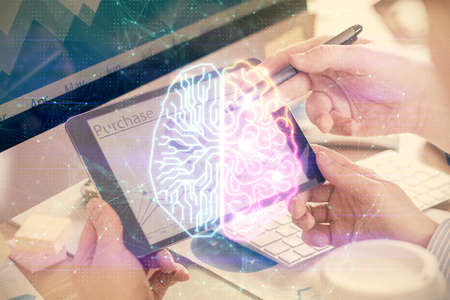 Double exposure of man's hand holding and using a digital device and brain hologram drawing. Data...