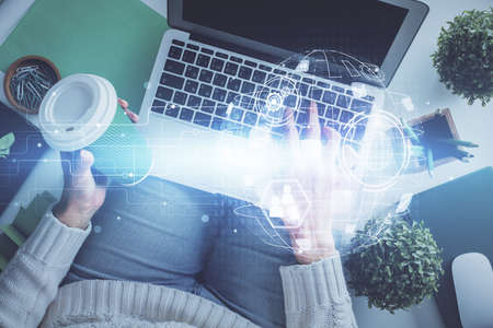 Double exposure of woman hands working on computer and social network theme hologram drawing. Top View. People connection concept.の写真素材