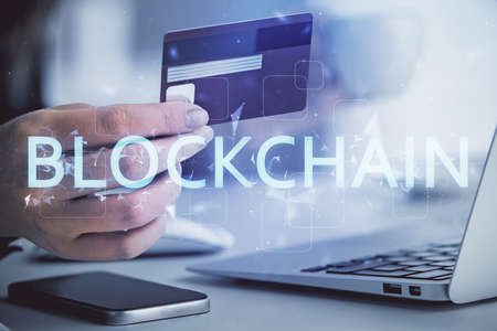 Multi exposure of woman on-line shopping holding a credit card and crypto theme drawing. Blockchain...