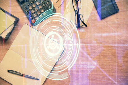 Double exposure of technology theme drawing over work table desktop. Top view. Global data analysis...